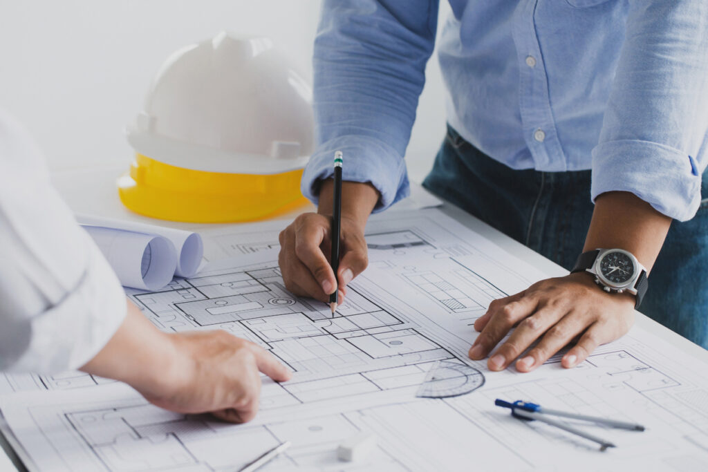 Team members of Central Illinois Construct go over a project's paperwork in Pekin IL