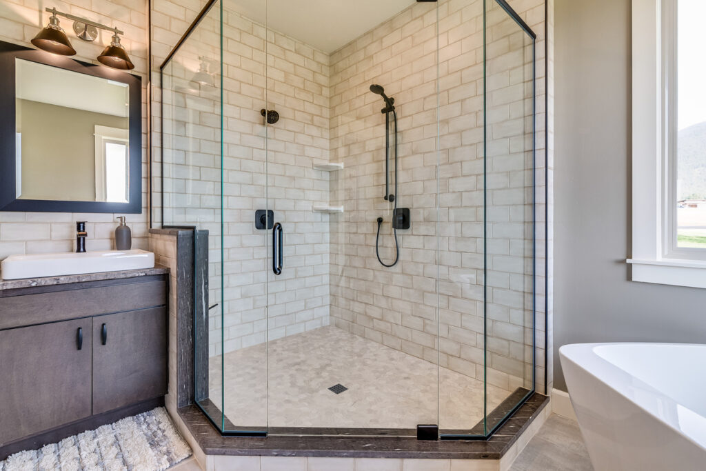 White subway tile and black matte shower head and fixtures from bathroom remodelers in Normal IL