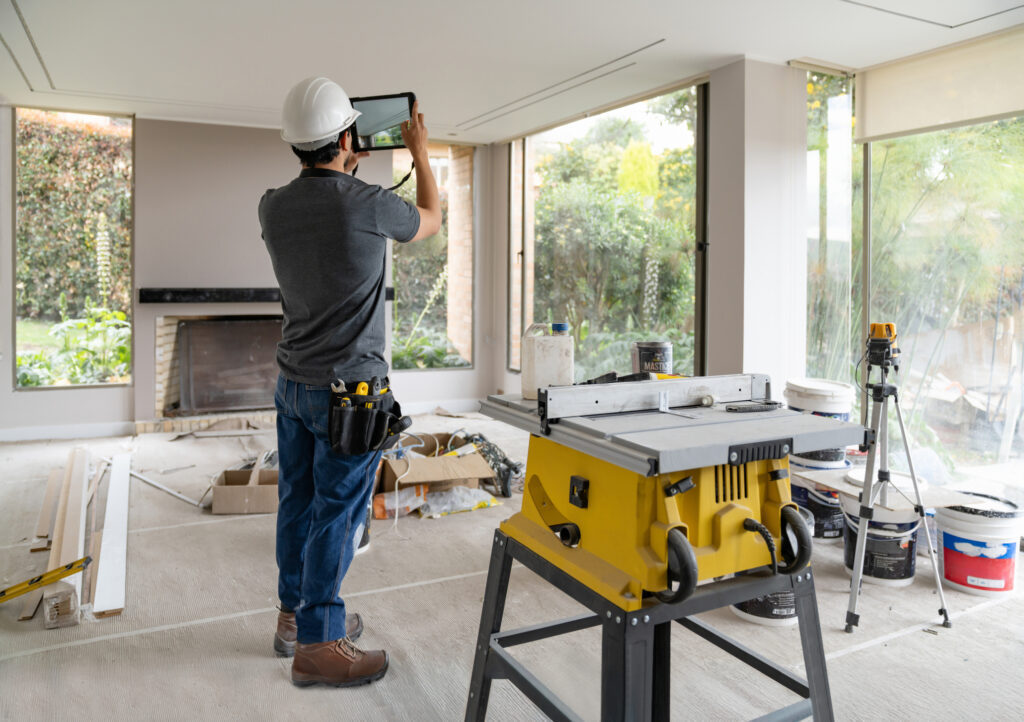 A team member of Central Illinois Construct, home builders in Peoria IL, reviews their work inside of a home